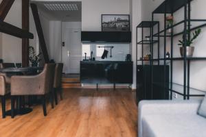 a living room with a kitchen and a dining room at ATRIO Apartments 2 in Trenčín +18 photos
