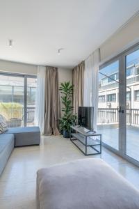 a large living room with a couch and a tv at The Artisan Suites in Athens