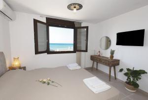 A television and/or entertainment centre at Seafront Villa Eirini