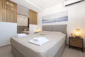 A bed or beds in a room at Seafront Villa Eirini