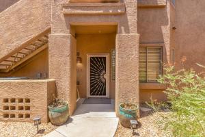 a front door of a house with two potted plants at Cochise #1056 Scottsdale condo in Scottsdale