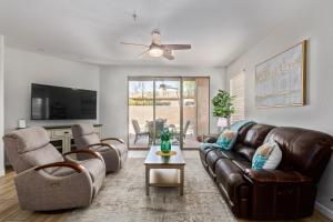 a living room with a brown leather couch and chairs at Cochise #1056 Scottsdale condo in Scottsdale