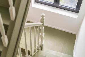 a stairway with a window and a stair case at Design Studio Gent modern en stijlvol met terras in Ghent