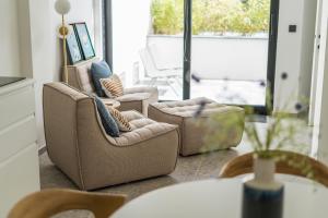 a living room with two chairs and a table at Design Studio Gent modern en stijlvol met terras in Ghent