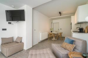 a living room with a couch and a table at Design Studio Gent modern en stijlvol met terras in Ghent