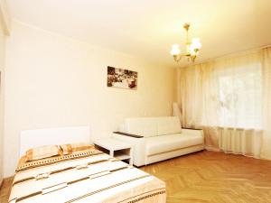 a living room with a bed and a couch at ApartLux Sokolnicheskaya Two Rooms in Moscow