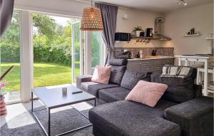 a living room with a couch and a table at Pet Friendly Home In Ytterby With Kitchen in Ytterby