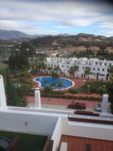 a view from the balcony of a building with a pool at Navigolf in La Cala de Mijas