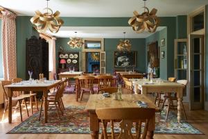 a dining room with wooden tables and chairs at The Exmoor Forest Inn in Simonsbath