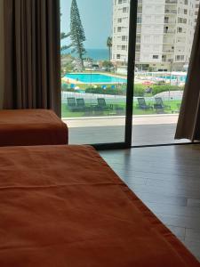 a hotel room with two beds and a view of a pool at AlgarPapa Rooms in Armação de Pêra +125 photos