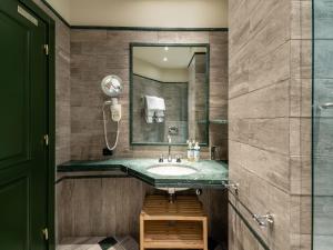 a bathroom with a sink and a mirror at Numa Milan Camperio in Milan +42 photos
