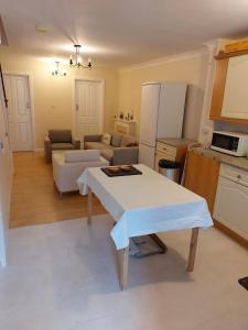 a kitchen and living room with a table and a refrigerator at Vibrant Single Room only for one adult in Southall