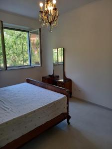 a bedroom with a bed and a dresser and a mirror at A casa dalla Lu in Chiavari