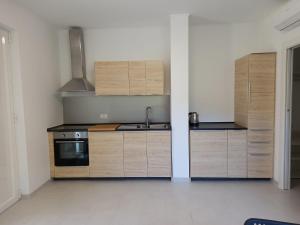 a kitchen with wooden cabinets and a sink at A casa dalla Lu in Chiavari