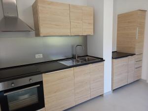 a kitchen with wooden cabinets and a sink at A casa dalla Lu in Chiavari +11 photos