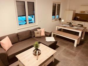 a living room with a couch and a table at Casaina in Weisweil
