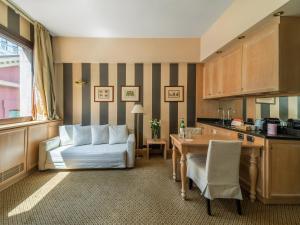 a living room with a white couch and a table at Numa Milan Camperio in Milan