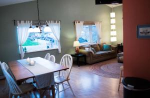 a living room with a table and chairs and a couch at Pioneer Inn Downtown in Homer