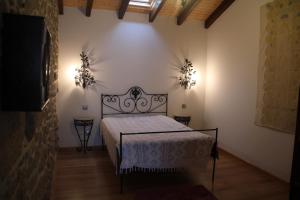 a bedroom with a bed and two lights on the wall at Casa Maria da Assunção in Vila Nova de Cerveira
