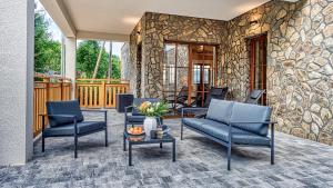 a patio with two blue chairs and a table at Aparthotel Przy Starej Piekarni VIP by ROYAL APARTS in Szklarska Poręba