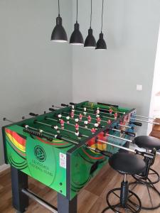 a foosball table in a room with stools at Ferienhaus "Zum Blauen Hause" in Wernigerode