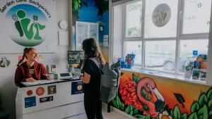 two women standing at a counter in a store at Garden Lane Backpackers in Dublin