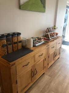 a wooden counter with dishes on top of it at Stag Lodge in Spean Bridge