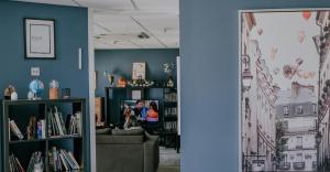 a room with a couch and a book shelf with books at Garden Lane Backpackers in Dublin