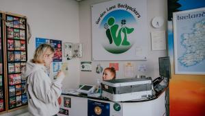 two women standing at a cash register in a store at Garden Lane Backpackers in Dublin