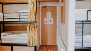 a door in a room with bunk beds at Garden Lane Backpackers in Dublin