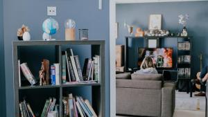 a living room with a book shelf filled with books at Garden Lane Backpackers in Dublin
