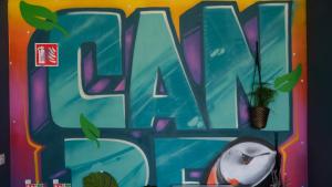 a painting of the word art on a wall at Garden Lane Backpackers in Dublin
