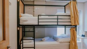 two bunk beds in a room with a bathroom at Garden Lane Backpackers in Dublin