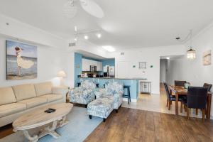 a living room with a couch and chairs and a table at Tidewater 2804 in Panama City Beach
