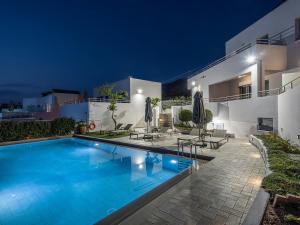a villa with a swimming pool at night at Sunset Elafonisi Apartments in Livadia