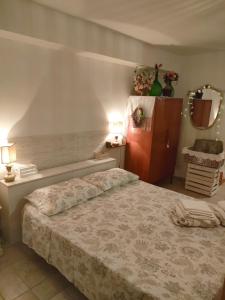 a bedroom with a large bed and two lamps at Casa GiuLy' in Leporano