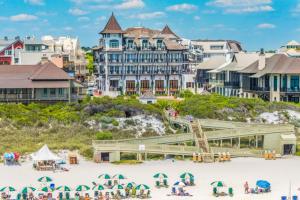 a group of people on the beach in front of a resort at The Shores Townhome #116 in Carillon Beach