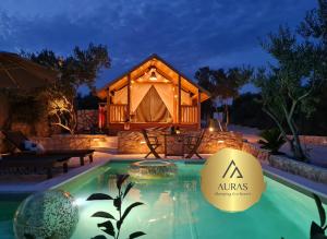a luxury tent with a pool in front of a house at AURAS - Glamping Eco Resort in Biograd na Moru