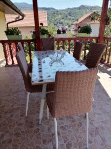 a dining table and chairs on a patio at Apartman" Ruža" in Višegrad