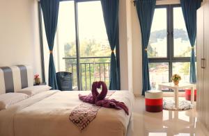 Postel nebo postele na pokoji v ubytování ATS Cameron Hotel & Apartments