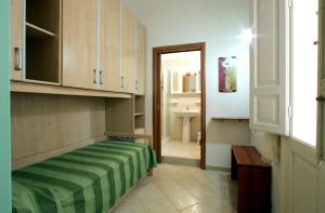 a bedroom with a bed and a sink in a room at La Dimora Siciliana in Trapani