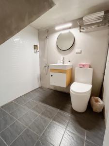 ein Bad mit einem WC und einem Waschbecken in der Unterkunft 逢甲菓子宿 in Taichung