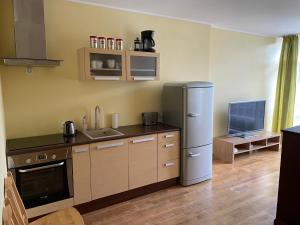 a kitchen with a refrigerator and a counter top at RÜÜTLI City Center Apartment in Pärnu