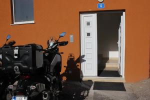 a motorcycle parked in front of a building at Apartments Kapisoda in Cetinje