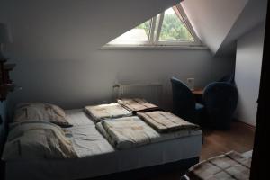 a bedroom with a bed and a desk and a window at Dom Wczasowy Pod Weską in Korbielów