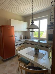 a kitchen with a table and a refrigerator at Ferienwohnung Eva in Mureck