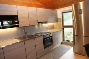 a kitchen with stainless steel appliances and a window at Isakssons Cottage 6 in Föglö