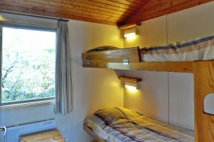 a bedroom with two bunk beds and a window at Isakssons Cottage 6 in Föglö