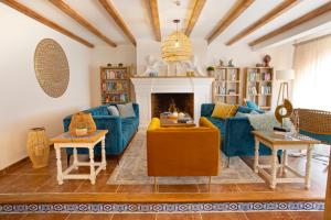 a living room with a blue couch and a fireplace at Apartamentos La Baranda in Torremolinos