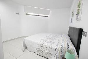 Habitación blanca con cama con manta blanca en Apartamento Bajo 3 Dúplex Marjal playa centro de Guardamar, en Guardamar del Segura